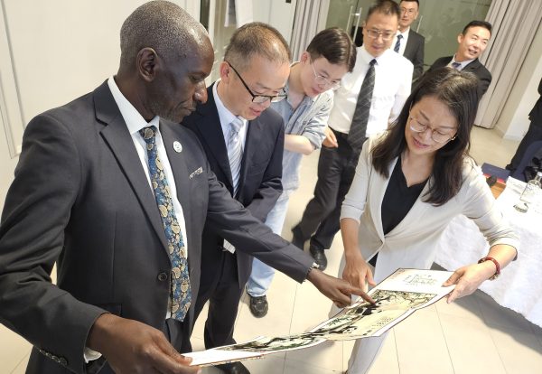 NARO Director General, Dr. Yona Baguma (left) interacting with the team from the Southwest Minzu University of China after the meeting at Fontis Residences Hotel in Kampala on Wednesday.